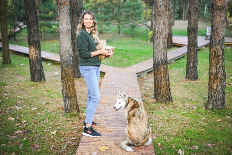 Mature adult woman carrying firewood.