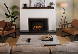 Electric insert fireplace against a white wall and wooden mantle.